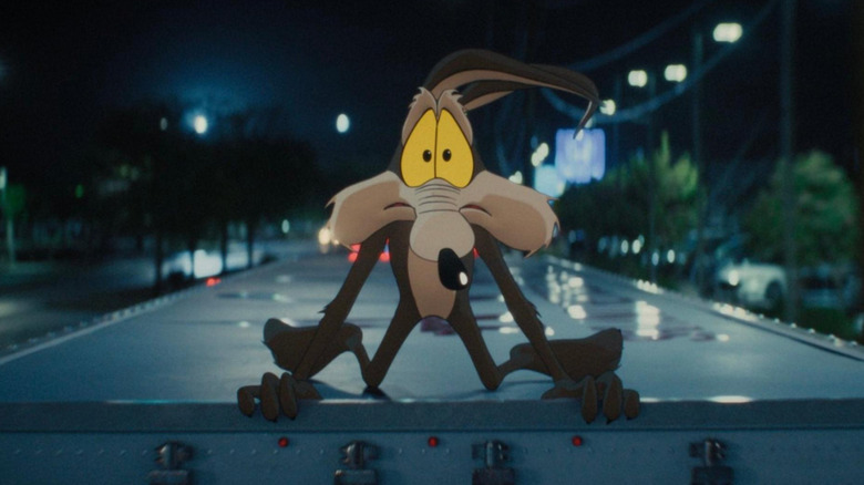 Coyote vs. Acme: Wile E. Coyote crouched on the top of a truck