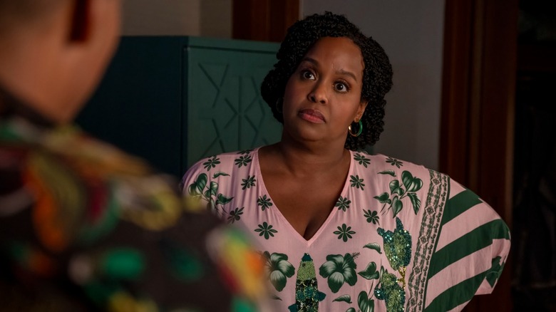 Natasha Rothwell's Belinda stands with hands on hips, looking at Nicholas Duvernay's Zion (facing away from camera) on The White Lotus