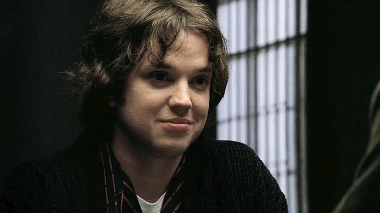 Zack Addy sitting across from someone in a prison on Bones