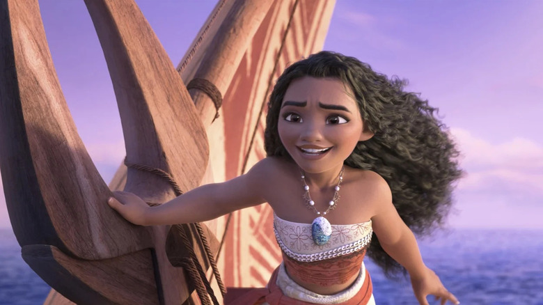 Moana (Auli'l Cravalho) smiles as she steers her ship in Moana 2
