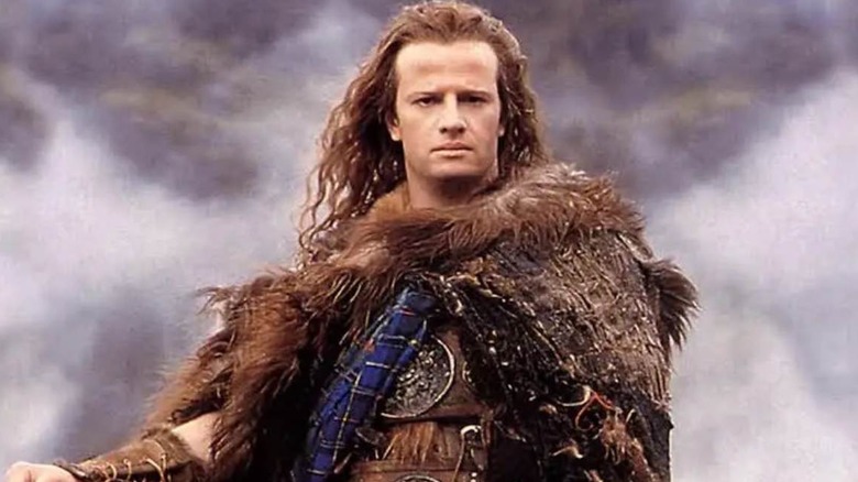 Christopher Lambert as Connor MacLeod stood on a hill in Highlander