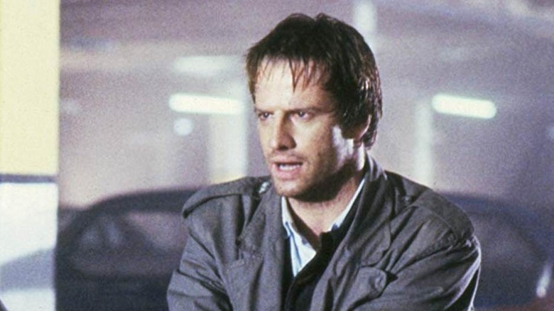 Christopher Lambert as Connor MacLeod in a parking garage in Highlander
