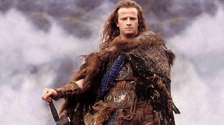 Christopher Lambert as Connor MacLeod stood on a hill in Highlander