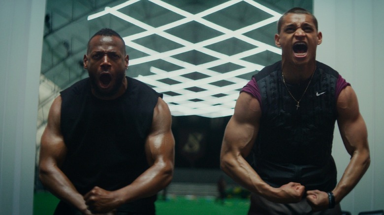 Marlon Wayans as Isaiah White and Tyriq Withers as Cameron Cade flexing their muscles and letting out a scream while training in Him