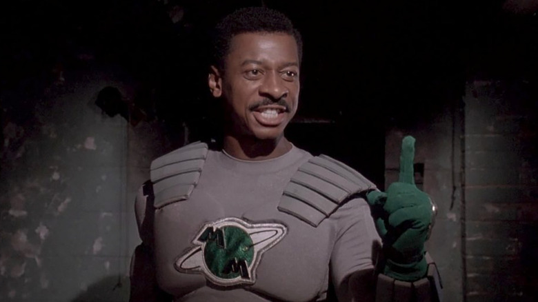 Robert Townsend as Meteor Man holding up his finger in The Meteor Man