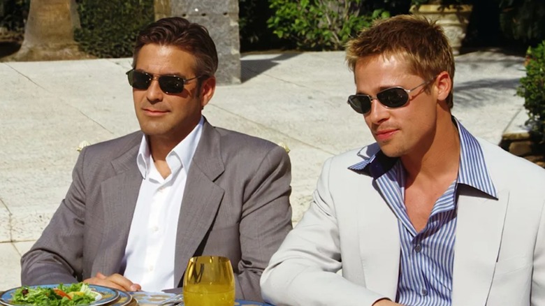 Danny and Rusty smile while planning their iconic heist in Ocean's Eleven