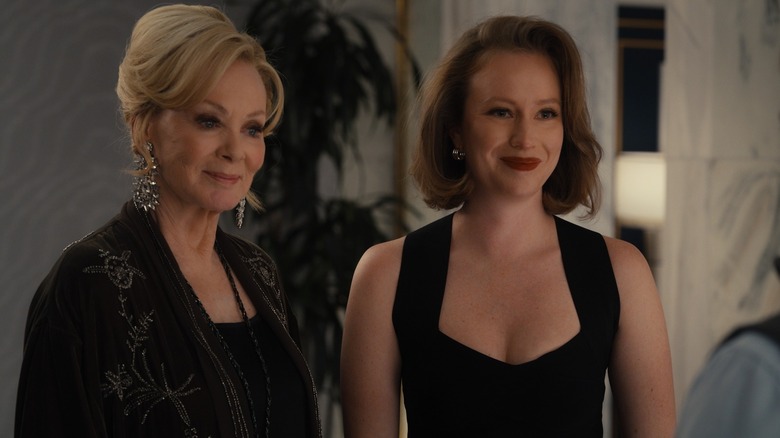 Deborah and Ava dressed up and smiling at someone on Hacks