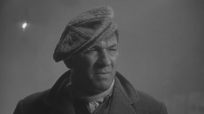 Victor McLaglen strikes a stoic pose in the fog as Gypo Nolan in The Informer
