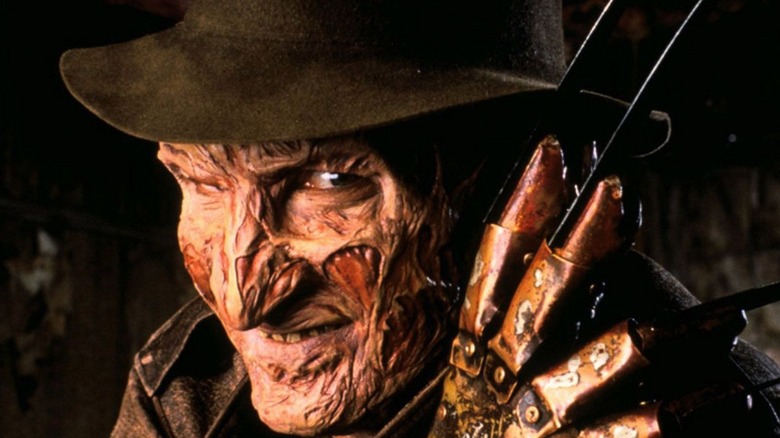 Freddy Krueger poses with claw and hat