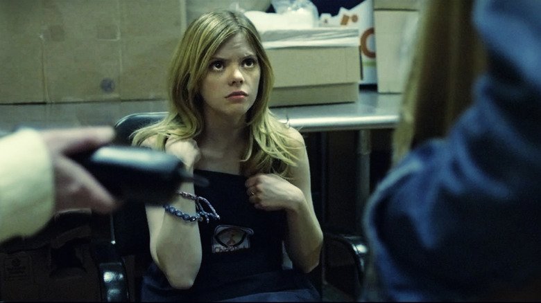 A young woman sits in office chair