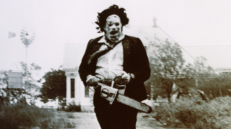 Leatherface runs down the path