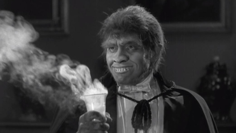 Fredric March as Mr. Hyde, holding potion