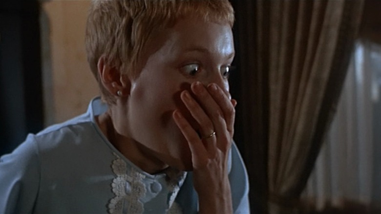 Mia Farrow as Rosemary in Rosemary's Baby, hand clutched to her mouth in shock