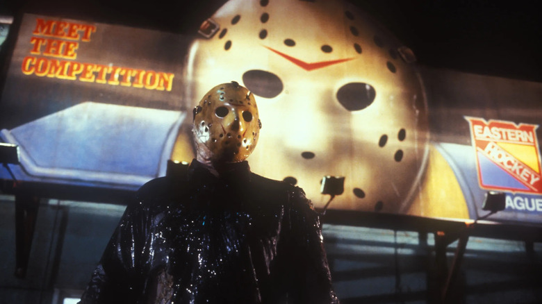 Jason standing in front of a hockey mask billboard