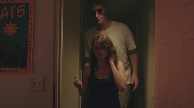 Olivia Luccardi stands with giant behind her