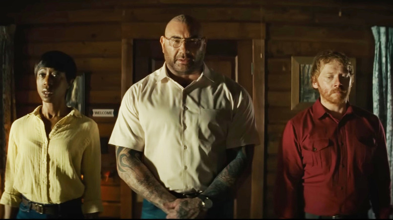 Dave Bautista Rupert Grint standing in line Knock at the Cabin