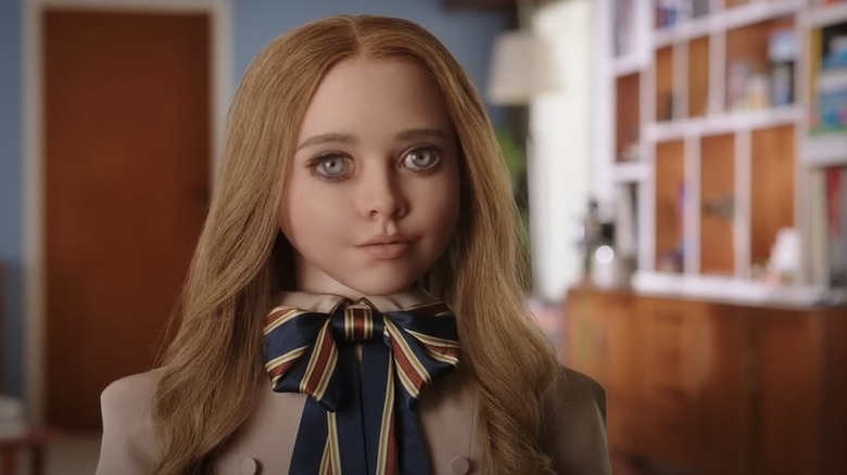 The M3GAN doll standing inside