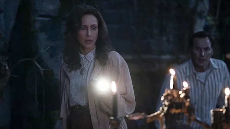 Vera Farmiga and Patrick Wilson looking scared inside of stone structure