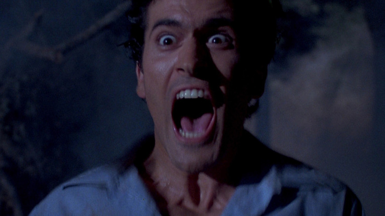 Ash Williams confronted by a demon in Evil Dead II