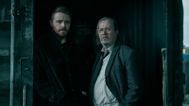 Jack Lowden as River Cartwright and Gary Oldman as Jackson Lamb standing together in Slow Horses