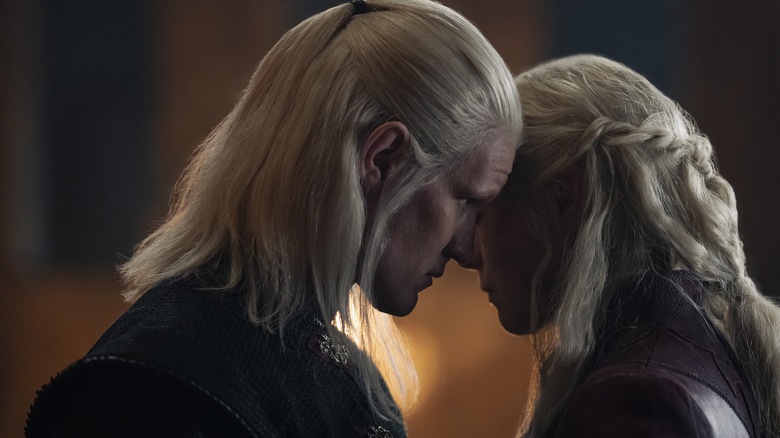 Rhaenyra and Daemon touching heads in House of the Dragon