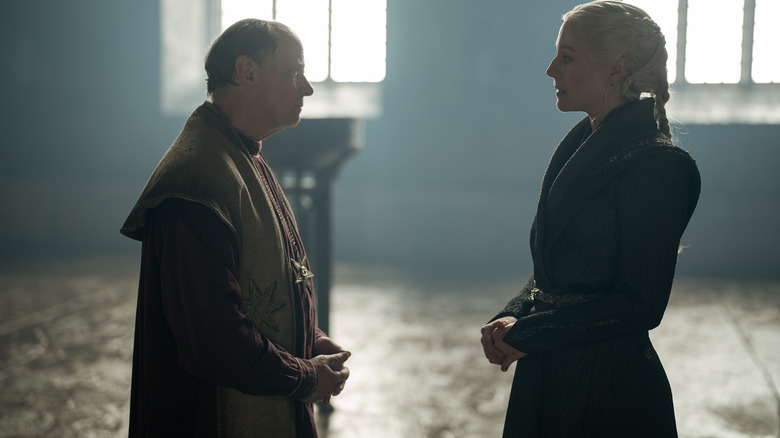 Emma D'Arcy as Rhaeynra Targaryen standing in a throne room opposite Simon Chandler as the High Septon in House of the Dragon
