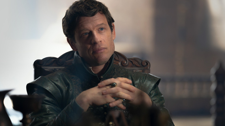 James Norton as Ormund Hightower seated at a table with his hands folded in House of the Dragon