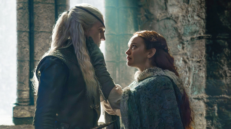 Ewan Mitchell as Aemond Targaryen standing close to Olivia Cooke as Alicent Hightower in House of the Dragon