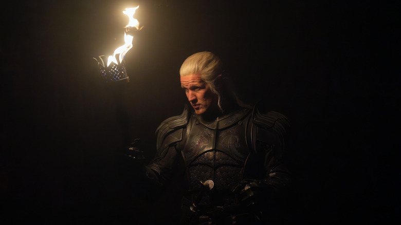 Daemon holding a torch in the Red Keep prisons on House of the Dragon