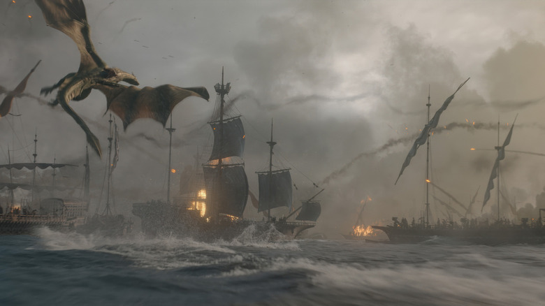A dragon attacks a fleet of ships on fire in a stormy sea in House of the Dragon