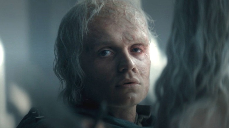 Aegon II with a sword to his brother's throat unsure if he wants to kill him in House of the Dragon
