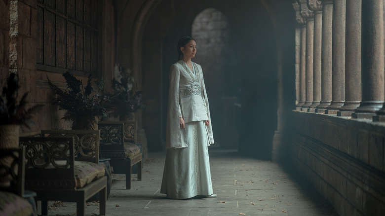 Sonoya Mizuno as Mysaria standing in an empty hallway and looking out the windows in House of the Dragon