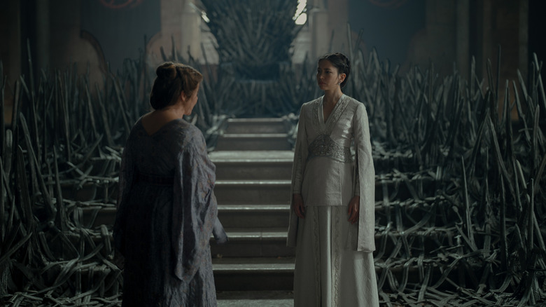 Sonoya Mizuno as Mysaria standing by the steps leading to a throne next to Michelle Bonnard as Madam Sylvi in House of the Dragon