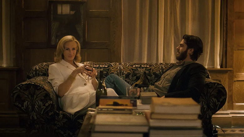 Alma and Hank talking and sitting on a couch in After the Hunt