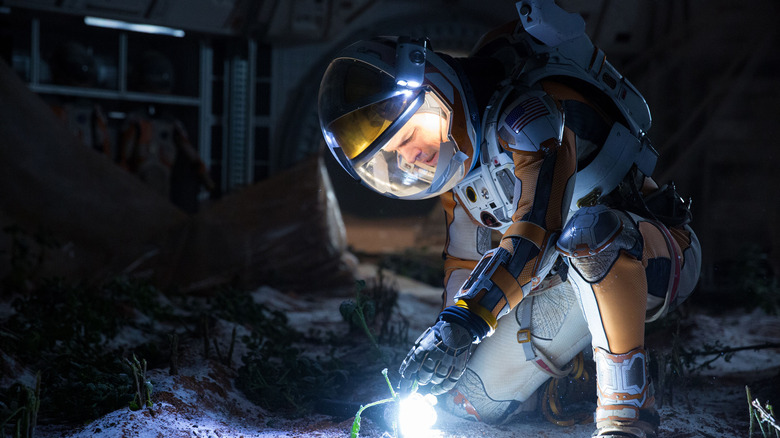 Matt Damon as Mark Watney looking at his dead plants in The Martian