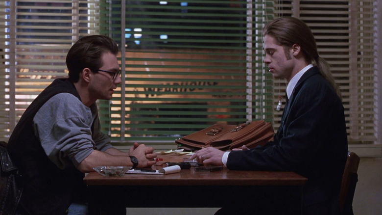 Daniel sitting with Lous at a table in Interview with the Vampire