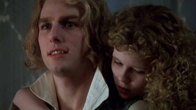 Lestat with Claudia hanging around his neck in Interview with the Vampire