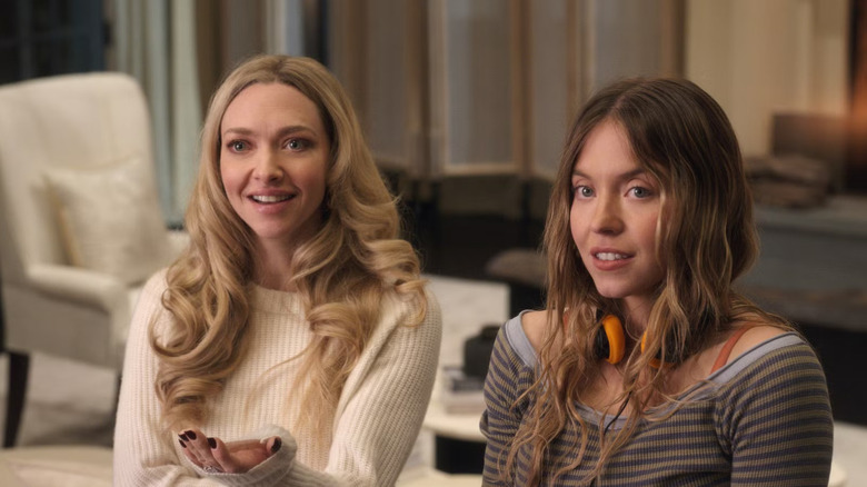 Nina smiling and Millie looking uncomfortable in The Housemaid