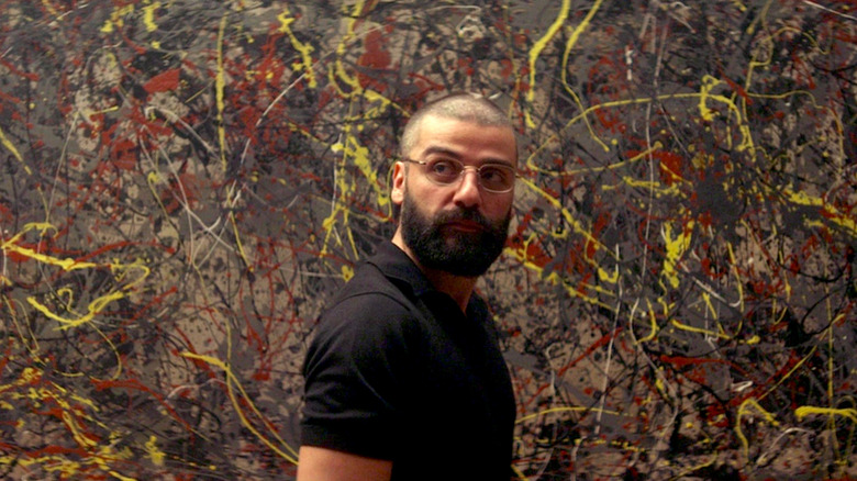 Nathan stands in front of a Jackson Pollock painting in "Ex Machina"