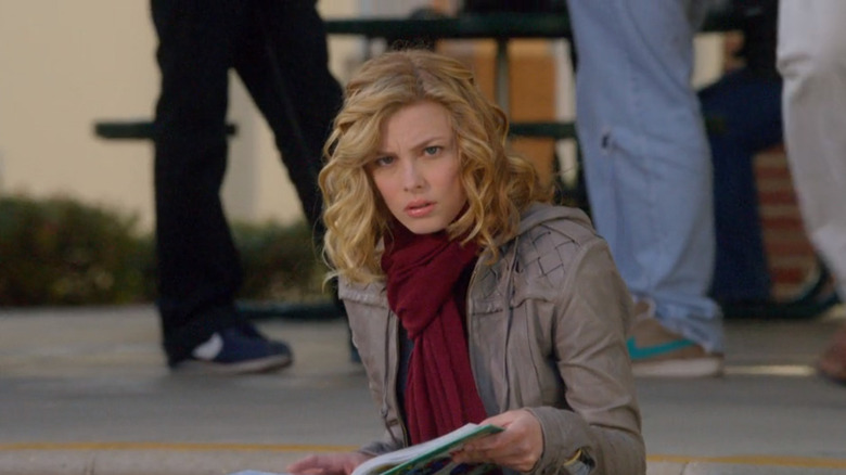 Britta sitting and holding books