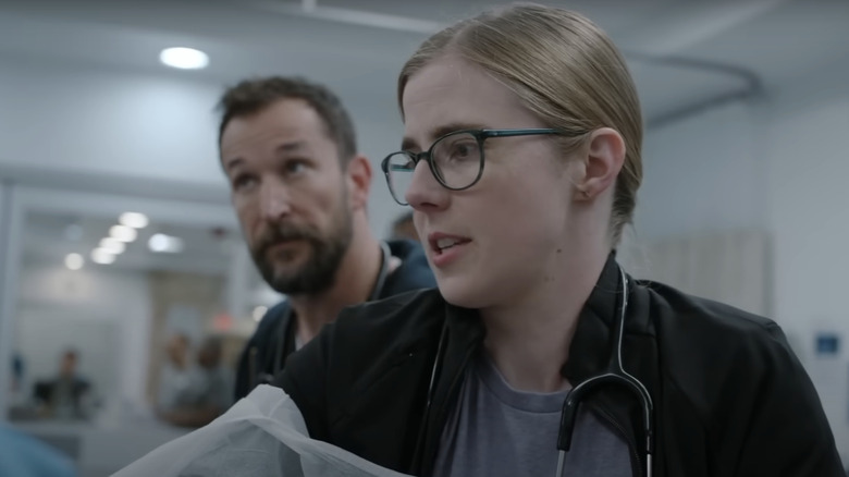Taylor Dearden's Dr. Melissa King is working in a patient while Noah Wlyle's Dr. Michael Robinavitch is watching in a pit