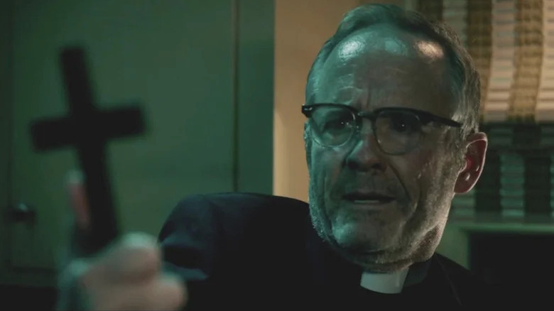 Father Callahan holding a cross in 'Salem's Lot