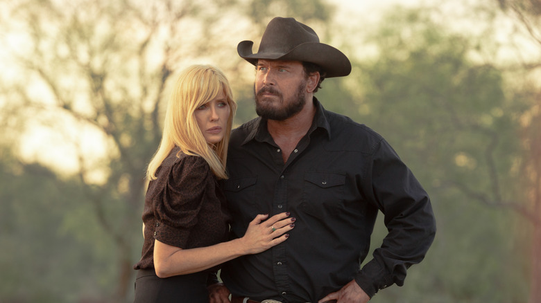 Cole Hauser's Rip Wheeler and Kelly Reilly's Beth Dutton stand together outside in Dutton Ranch