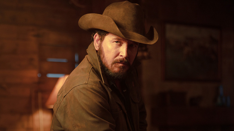 Cole Hauser's Rip Wheeler sits on the edge of a pool table in Dutton Ranch