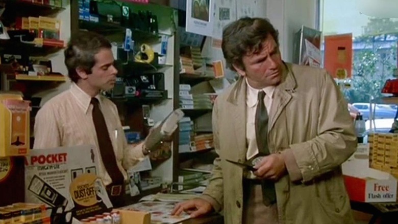 The Columbo Lieutenant is overlooking his shoulder, confusing, as a cashier picked up his purchase in a photography shop 