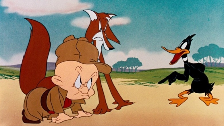 Daffy in front of a fox and Elmer Fudd, both mad, in What Makes Daffy Duck