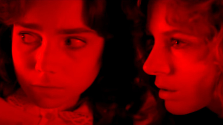 Suzy and a fellow classmate bathed in red light