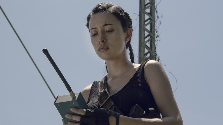 Christian Serratos as Rosita staring at a radio in The Walking Dead