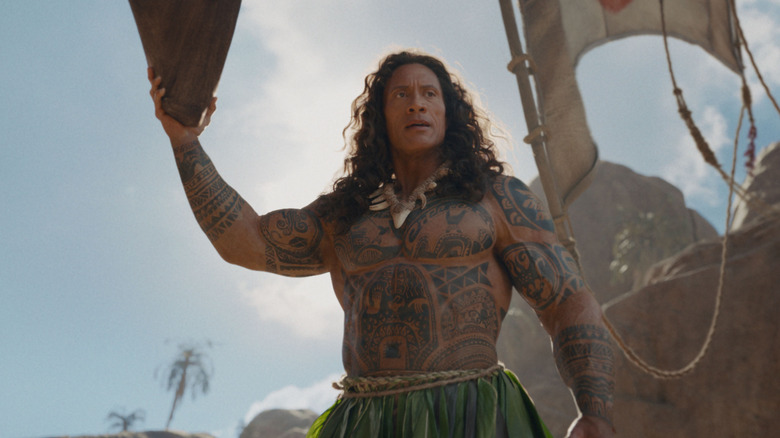 Dwayne Johnson as Maui holding up a boat in Moana (2026)