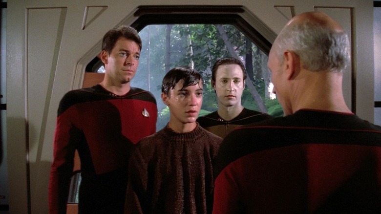 Riker, a wet Wesley, and Data looking at Picard outside of a holodeck on Star Trek; The Next Generation